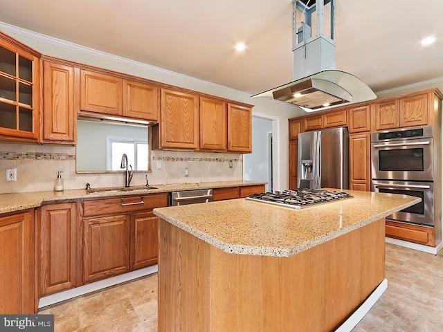 kitchen with stainless steel appliances, glass insert cabinets, ornamental molding, a kitchen island, and a sink