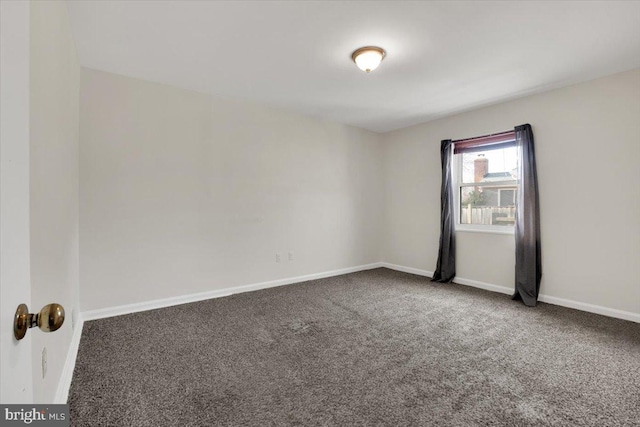spare room with carpet flooring and baseboards