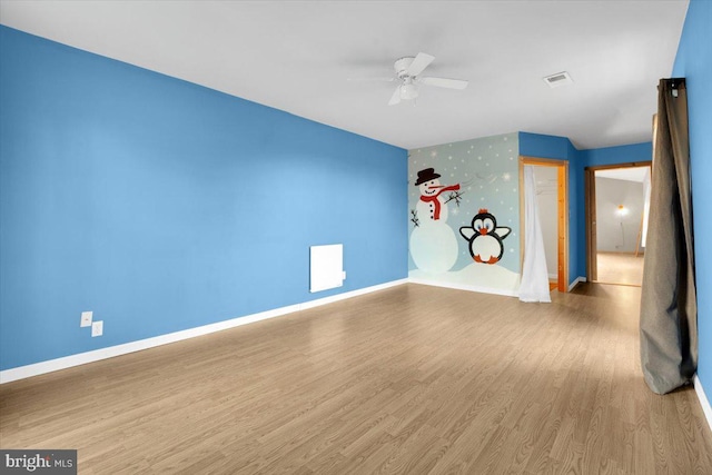 interior space with visible vents, baseboards, and wood finished floors