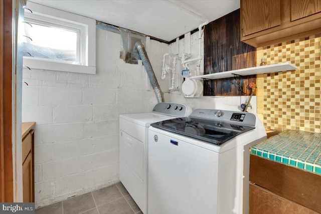 laundry room featuring laundry area, light tile patterned floors, and washer and dryer