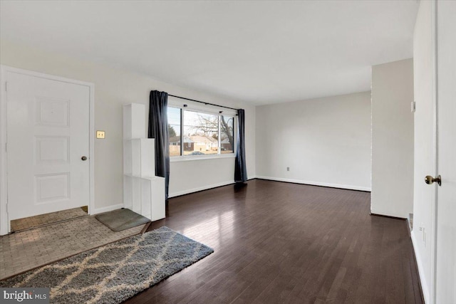 interior space with baseboards and wood finished floors
