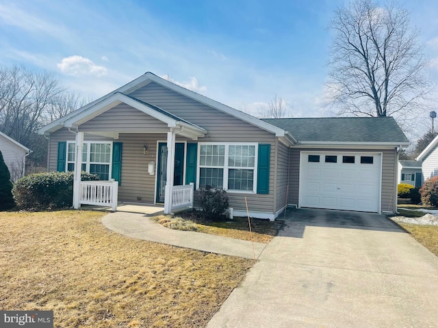 view of front of property featuring a front lawn, covered porch, driveway, and an attached garage