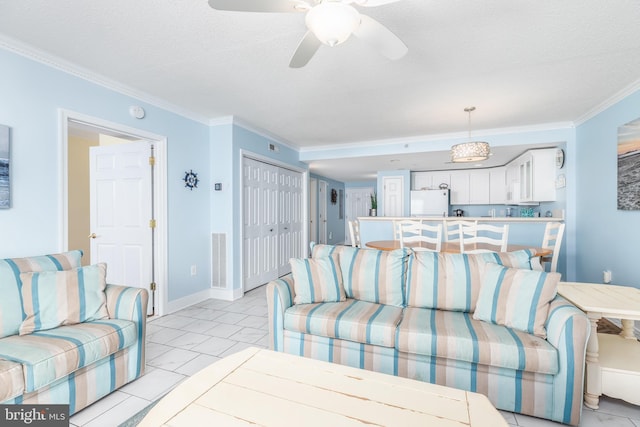 living room with a textured ceiling, ornamental molding, a ceiling fan, and baseboards