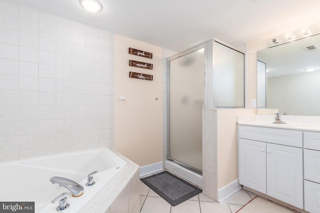 bathroom featuring a stall shower, visible vents, a garden tub, tile patterned flooring, and vanity