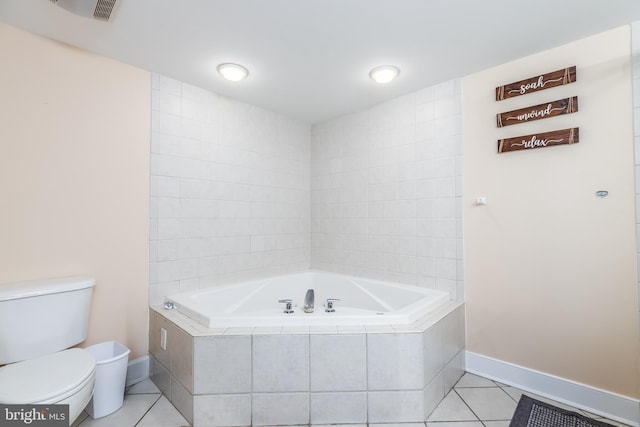 full bath featuring a bath, baseboards, toilet, and tile patterned floors