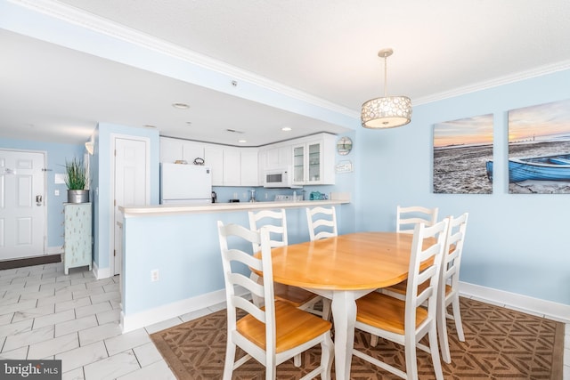 dining room with baseboards and ornamental molding