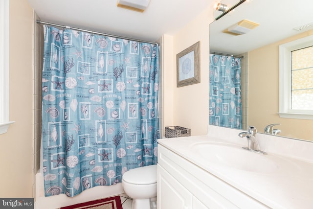 bathroom with visible vents, shower / tub combo with curtain, vanity, and toilet