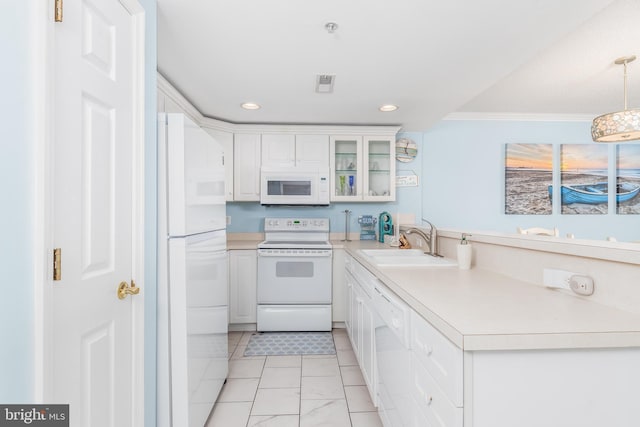 kitchen featuring white appliances, a sink, white cabinetry, light countertops, and glass insert cabinets