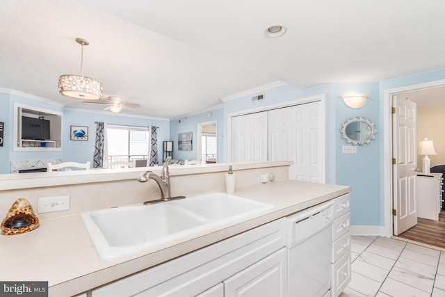 kitchen with crown molding, a sink, hanging light fixtures, and dishwasher