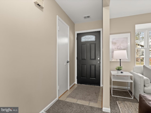 foyer with visible vents, baseboards, and light tile patterned floors