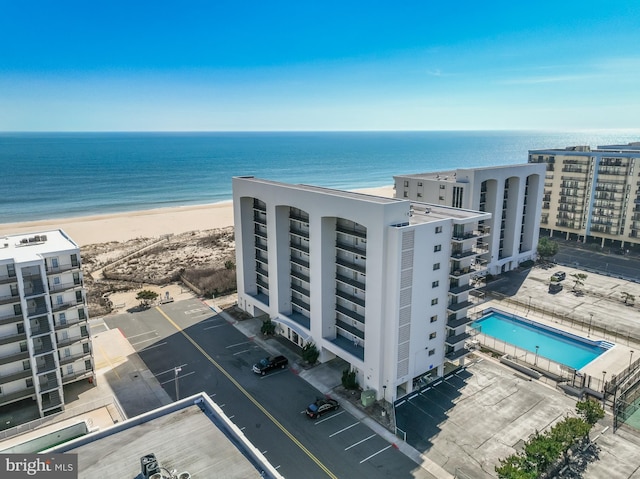 drone / aerial view featuring a water view and a view of the beach