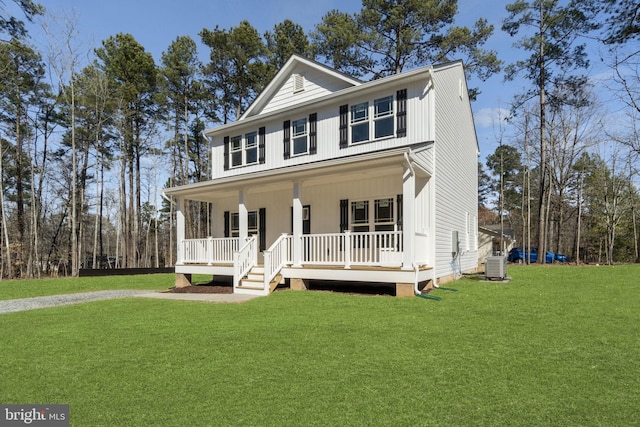 view of front of house featuring covered porch, a front yard, and central air condition unit