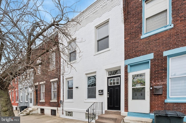 view of front facade featuring entry steps and brick siding