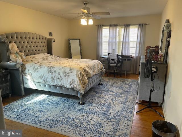 bedroom with a ceiling fan and wood finished floors