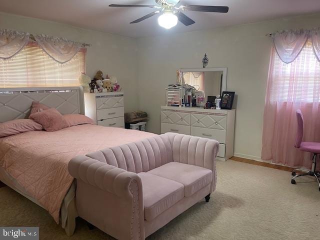 bedroom with ceiling fan and light colored carpet