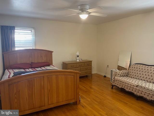 bedroom with ceiling fan and wood finished floors