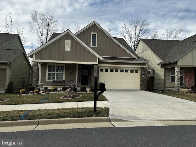 craftsman-style home with a standing seam roof, metal roof, a garage, stone siding, and driveway