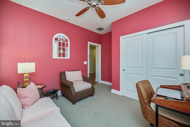 carpeted home office with a ceiling fan, visible vents, and baseboards