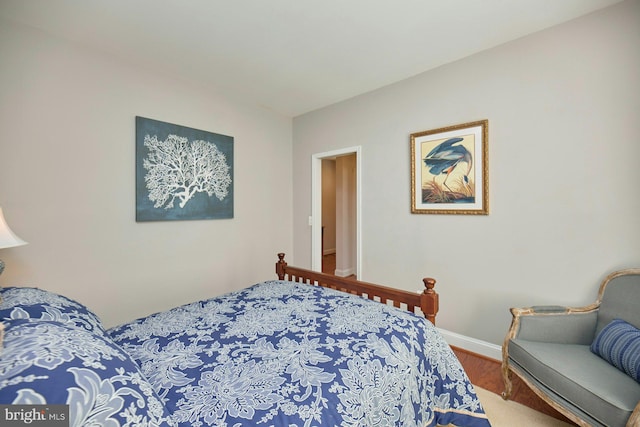 bedroom featuring wood finished floors and baseboards