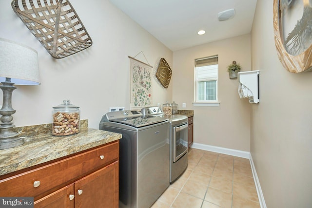 laundry area featuring light tile patterned flooring, recessed lighting, baseboards, cabinet space, and washing machine and clothes dryer