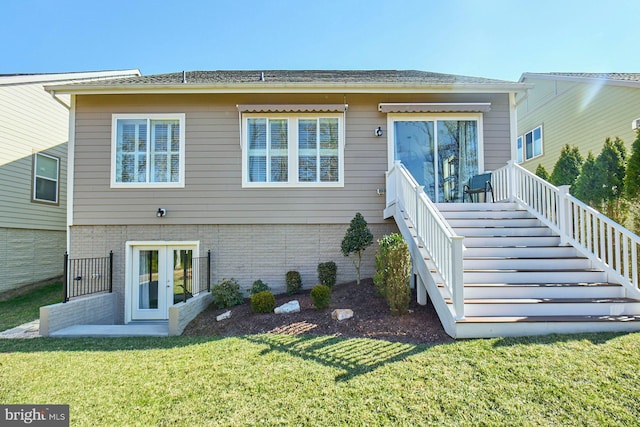 back of property with french doors, brick siding, a yard, and stairway