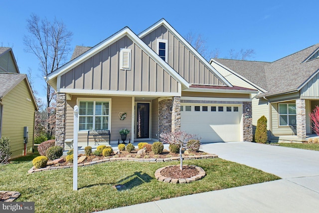 craftsman house featuring a porch, an attached garage, concrete driveway, board and batten siding, and a front yard