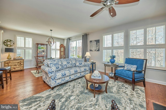 living room with plenty of natural light, wood finished floors, and baseboards