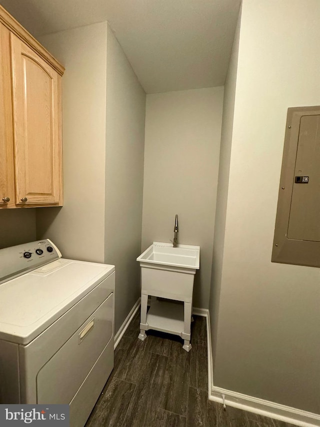 laundry area with washer / clothes dryer, cabinet space, dark wood-type flooring, electric panel, and baseboards