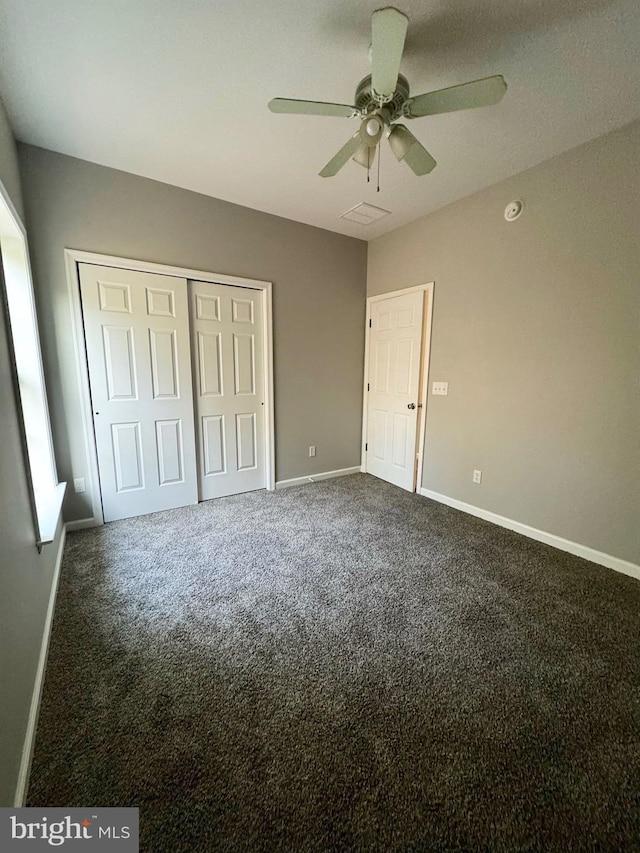 unfurnished bedroom with carpet floors, a closet, and baseboards