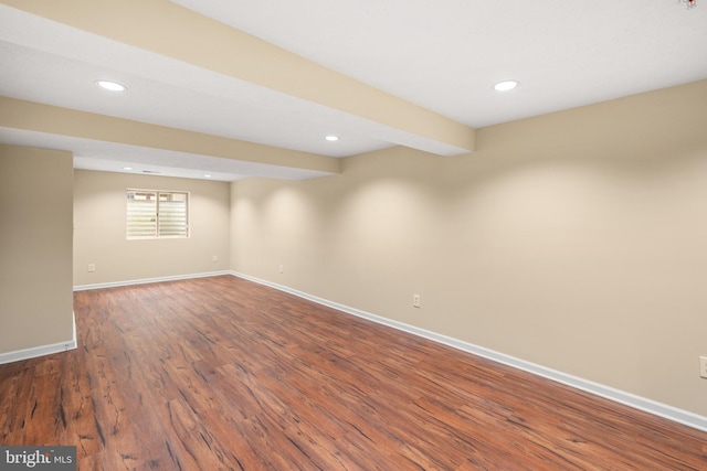 basement featuring dark wood-style flooring, recessed lighting, and baseboards