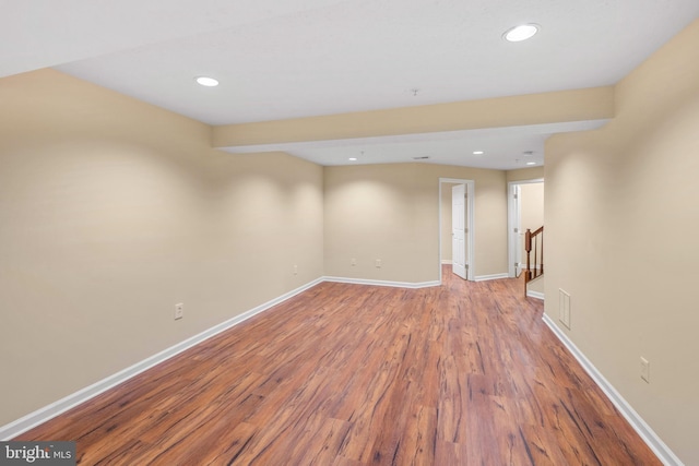 basement featuring stairway, recessed lighting, wood finished floors, and baseboards