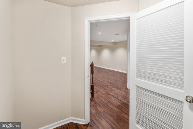 hallway with baseboards and dark wood finished floors