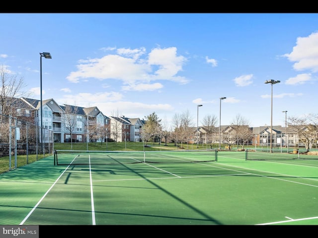 view of sport court featuring a residential view and fence