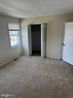 unfurnished bedroom with carpet floors and baseboards
