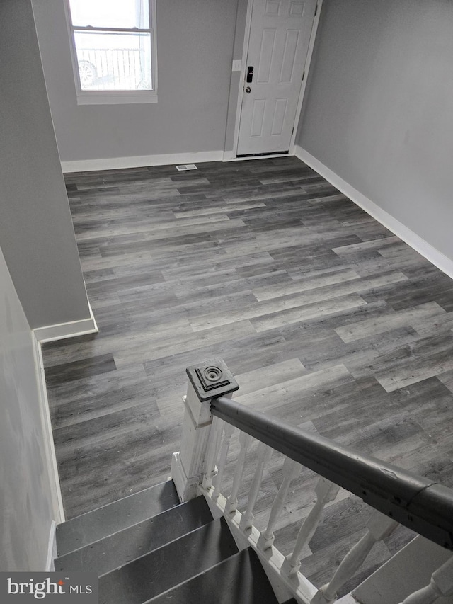 entryway featuring baseboards and wood finished floors