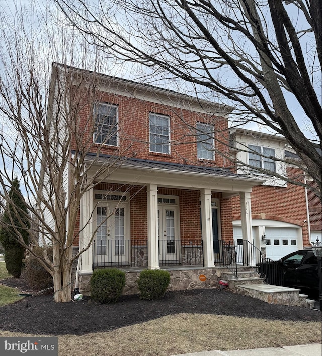 view of front of property featuring covered porch, brick siding, and an attached garage