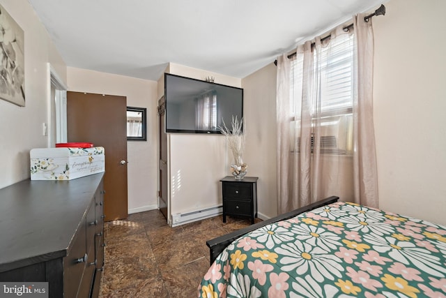 bedroom featuring baseboards and a baseboard heating unit