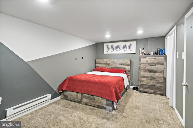 carpeted bedroom featuring a baseboard heating unit and baseboards