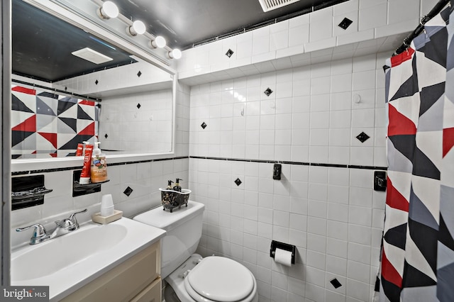 bathroom featuring toilet, vanity, tile walls, and a shower with curtain