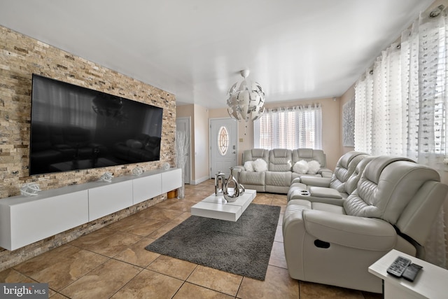 tiled living room with an inviting chandelier