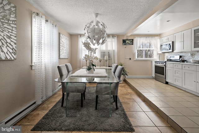 dining space with light tile patterned floors, baseboards, baseboard heating, a textured ceiling, and a chandelier