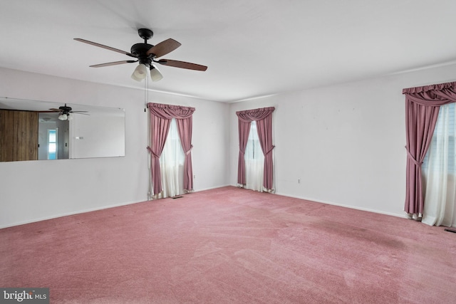 unfurnished room with carpet floors and baseboards