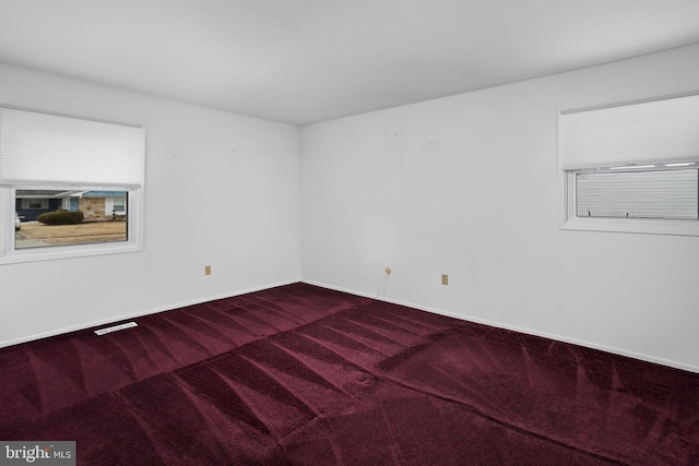 carpeted spare room with baseboards