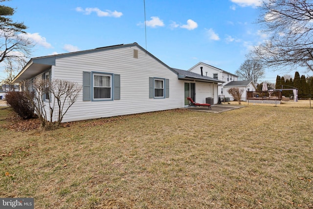 back of house with a deck, a yard, central AC unit, and a patio