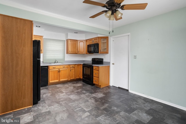 kitchen featuring light countertops, brown cabinetry, a sink, black appliances, and baseboards