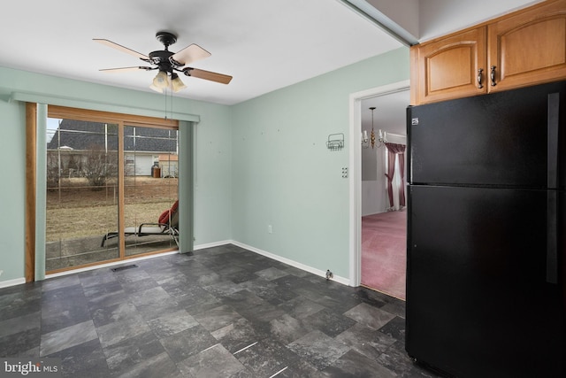 interior space with stone finish floor, visible vents, baseboards, and ceiling fan with notable chandelier