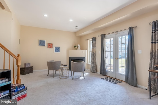 living area with recessed lighting, french doors, carpet floors, and stairway