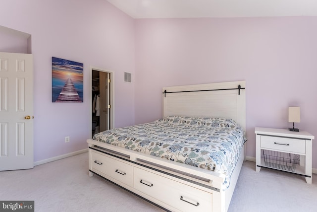 bedroom featuring visible vents, light carpet, and baseboards