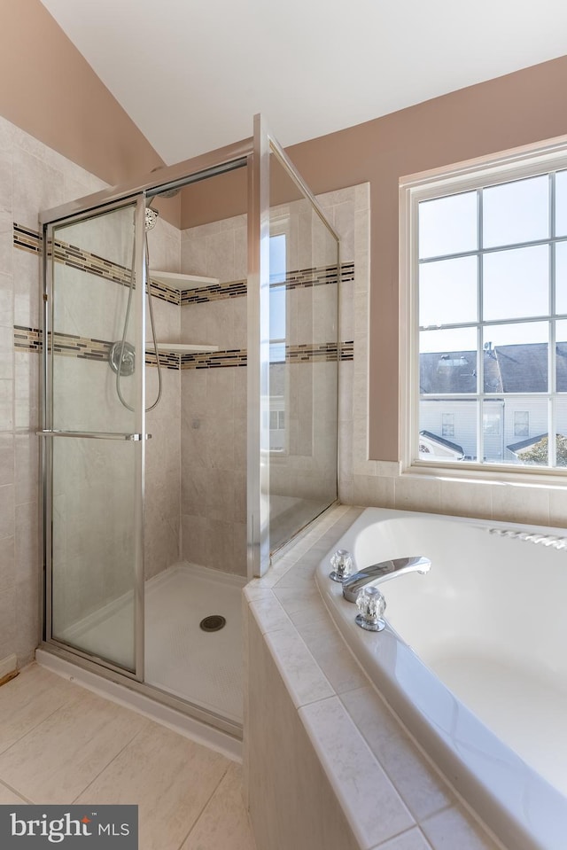 full bath featuring a bath, a shower stall, and tile patterned flooring