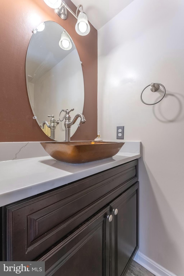 bathroom featuring baseboards and vanity